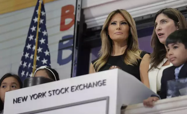 FILE - New York Stock Exchange President Stacey Cunningham, right, and first lady Melania Trump, with the help of students from the United Nations International School, ring the opening bell of the NYSE in New York, Sept. 23, 2019. (AP Photo/Seth Wenig, File)