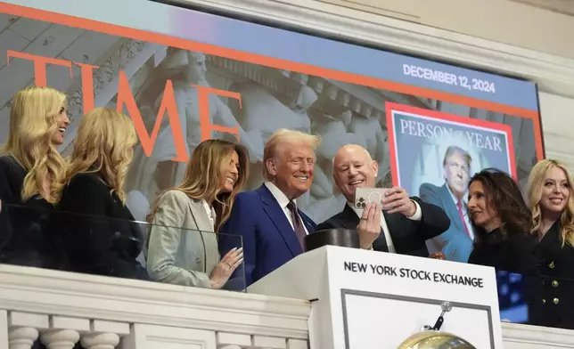 President-elect Donald Trump stands for a selfie after ringing the opening bell at the New York Stock Exchange, Thursday, Dec. 12, 2024, in New York. (AP Photo/Alex Brandon)