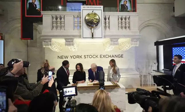 President-elect Donald Trump signs a guest book after ringing the opening bell at the New York Stock Exchange, Thursday, Dec. 12, 2024, in New York. (AP Photo/Alex Brandon)