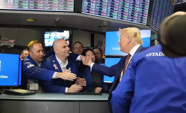 President-elect Donald Trump is greeted by traders, as he walks the floor of the New York Stock Exchange, Thursday, Dec. 12, 2024, in New York. (AP Photo/Alex Brandon)