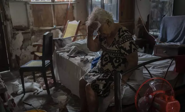 Margarita Salazar, 82, wipes the sweat off with a tissue inside her home amid high heat in Veracruz, Mexico, June 16, 2024. (AP Photo/Felix Marquez)