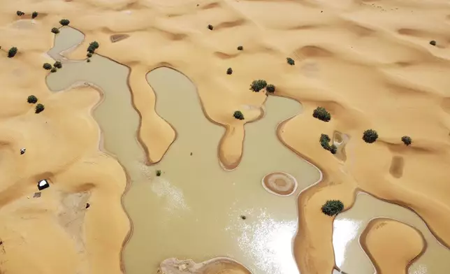 Pools of water caused by heavy rainfall between sand dunes are visible in the desert town of Merzouga, Morocco, Oct. 2, 2024. (AP Photo)