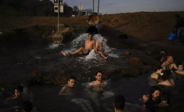 People enjoy a hot water pool near Mount Bental in the Israeli-controlled Golan Heights, Dec. 7, 2024. (AP Photo/Matias Delacroix)