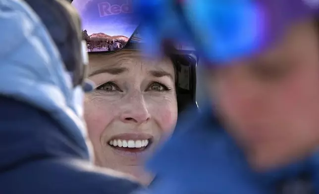 Lindsey Vonn talks with a coach after competing in a Super G skiing race at Copper Mountain Ski Resort, Sunday, Dec. 8, 2024, in Copper Mountain, Colo. (AP Photo/Robert F. Bukaty)