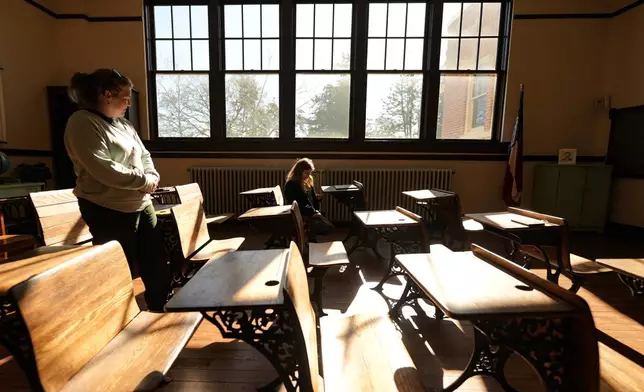 Gail Hassler and her mother Sara Hassler view a classroom inside the Jimmy Carter National Historical Park, Monday, Dec. 30, 2024, in Plains, Ga. Former President Carter died Sunday at the age of 100. (AP Photo/Mike Stewart)