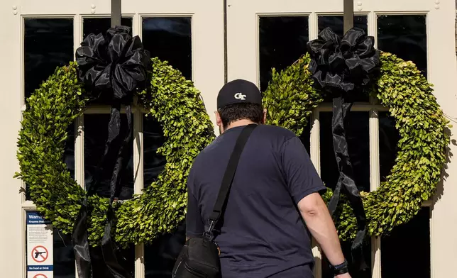 A man enters the Jimmy Carter National Historical Park, Monday, Dec. 30, 2024, in Plains, Ga. Former President Carter died Sunday at the age of 100. (AP Photo/Mike Stewart)