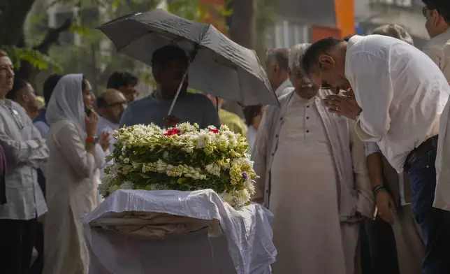 Bollywood actor Boman Irani, right, pays homage to Shyam Benegal, a renowned Indian filmmaker who passed away on Monday, during Benegal's funeral in Mumbai, India, Tuesday, Dec. 24, 2024. (AP Photo/Rafiq Maqbool)