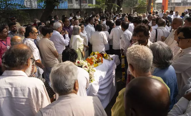 Friends and relatives pay homage to Shyam Benegal, a renowned Indian filmmaker who passed away on Monday, during Benegal's funeral in Mumbai, India, Tuesday, Dec. 24, 2024. (AP Photo/Rafiq Maqbool)