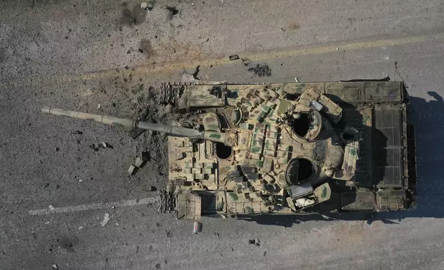 An abandoned Syrian army armoured vehicle sits on a road controlled by Syrian insurgents in the outskirts of Hama, Syria, Tuesday Dec. 3, 2024.(AP Photo/Ghaith Alsayed)