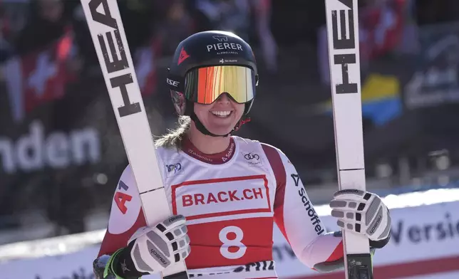 Austria's Cornelia Huetter celebrates at the finish area of an alpine ski, women's World Cup super G, in St. Moritz, Switzerland, Saturday, Dec. 21, 2024. (AP Photo/Giovanni Auletta)