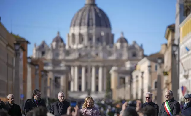 Italian Premier Giorgia Meloni, center, backdropped by St.Peter's Basilica, delivers her speech in Rome, Italy, Monday, Dec. 23, 2024 during the opening ceremony of a new pedestrian area in the nearby of the Vatican, just ahead of the Jubilee Year, an event expected to draw millions of visitors to the Eternal City. (AP Photo/Andrew Medichini)