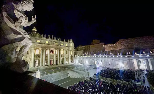 Faithful and pilgrims wait in St. Peter's Square for the opening of the holy door of St. Peter's Basilica at The Vatican, Tuesday, Dec. 24, 2024, marking the start of the Catholic jubiliar year 2025. (AP Photo/Gregorio Borgia)