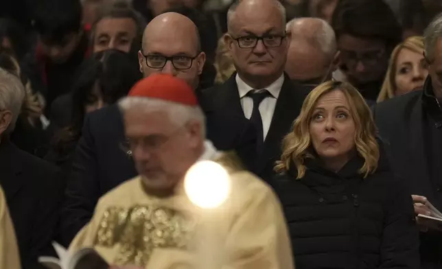 From right, Italian Premier Giorgia Meloni, Rome's Mayor Roberto Gualtieri, and House Speaker Lorenzo Fontana attend the Christmas Eve Mass in St. Peter's Basilica at The Vatican, Tuesday, Dec. 24, 2024, presided over by Pope Francis after opening the basilica's holy door marking the start of the Catholic jubiliar year 2025. (AP Photo/Andrew Medichini)