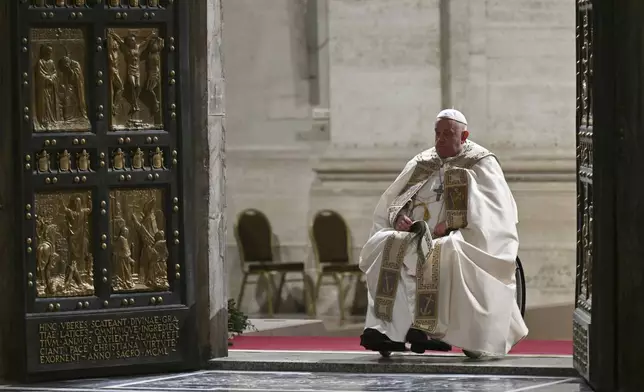 Pope Francis opens the Holy Door of St Peter's Basilica to mark the start of the Catholic Jubilee Year, at the Vatican, Dec. 24, 2024. (Alberto Pizzoli/Pool Photo via AP)