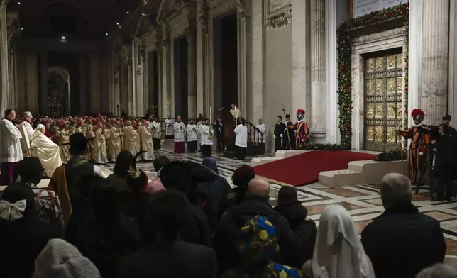 Pope Francis, third from left, celebrates a Christmas Eve Mass on the day the Pope opens the Holy Door to mark the opening of the 2025 Catholic Holy Year, or Jubilee, in St. Peter's Basilica, at the Vatican, Dec. 24, 2024. (Remo Casilli/Pool Photo via AP)