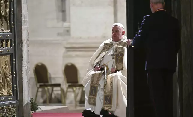 Pope Francis opens the Holy Door of St Peter's Basilica to mark the start of the Catholic Jubilee Year, at the Vatican, Dec. 24, 2024. (Alberto Pizzoli/Pool Photo via AP)