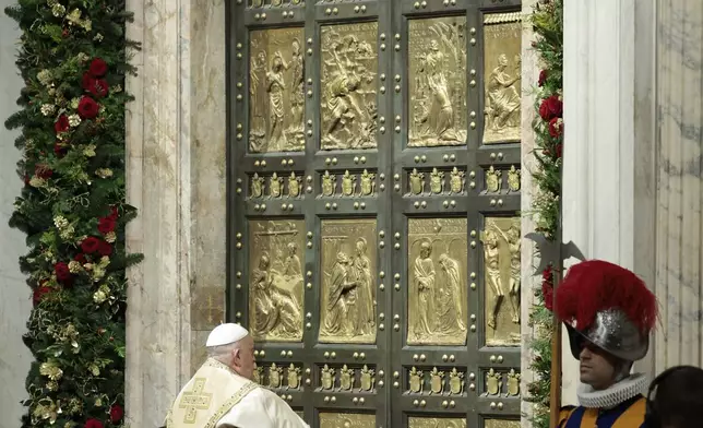 Pope Francis opens the Holy Door to mark the opening of the 2025 Catholic Holy Year, or Jubilee, in St. Peter's Basilica, at the Vatican, Dec. 24, 2024. (Remo Casilli/Pool Photo via AP)