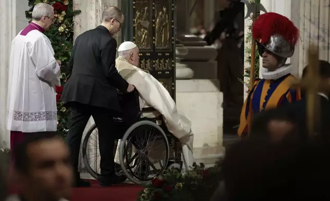 Pope Francis opens the Holy Door to mark the opening of the 2025 Catholic Holy Year, or Jubilee, in St. Peter's Basilica, at the Vatican, Dec. 24, 2024. (Remo Casilli/Pool Photo via AP)