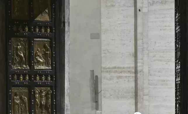 Pope Francis opens the Holy Door of St Peter's Basilica to mark the start of the Catholic Jubilee Year, at the Vatican, Dec. 24, 2024. (Alberto Pizzoli/Pool Photo via AP)