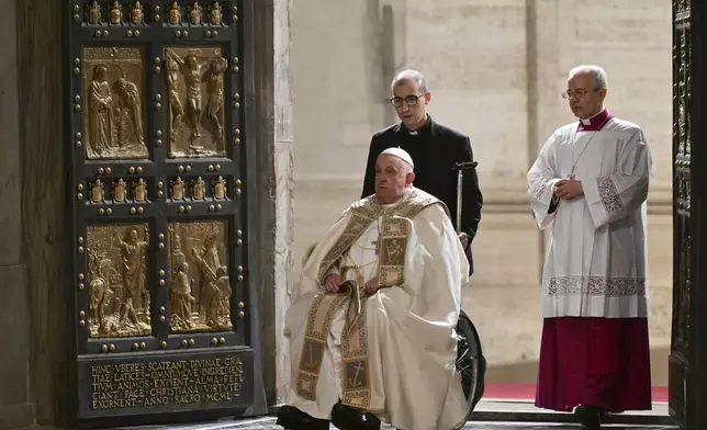 Pope Francis opens the Holy Door of St Peter's Basilica to mark the start of the Catholic Jubilee Year, at the Vatican, Dec. 24, 2024. (Alberto Pizzoli/Pool Photo via AP)