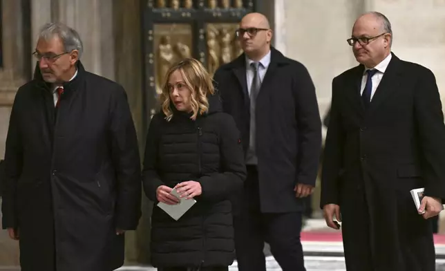 Italy's Prime Minister Giorgia Meloni, center left, and Rome's Mayor Roberto Gualtieri, right, pass through after Pope Francis opened the Holy Door to mark the opening of the 2025 Catholic Holy Year, or Jubilee, in St. Peter's Basilica, at the Vatican, Tuesday Dec. 24, 2024. (Alberto Pizzoli/Pool via AP)