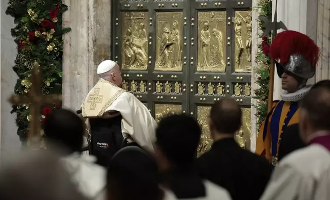 Pope Francis opens the Holy Door to mark the opening of the 2025 Catholic Holy Year, or Jubilee, in St. Peter's Basilica, at the Vatican, Dec. 24, 2024. (Remo Casilli/Pool Photo via AP)