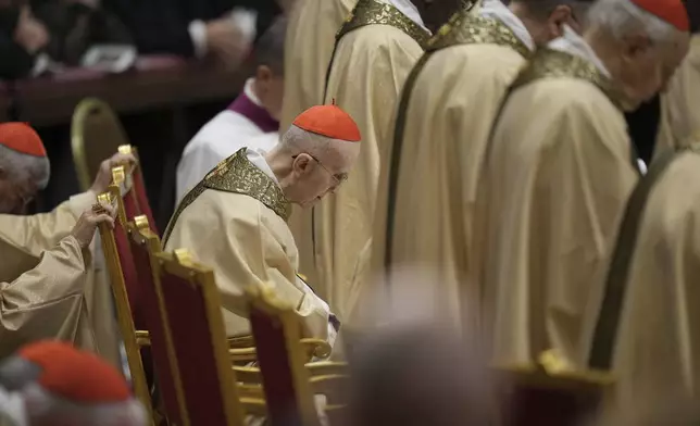 Cardinal Tarcisio Bertone follows Pope Francis presiding over the Christmas Eve Mass in St. Peter's Basilica at The Vatican, Tuesday, Dec. 24, 2024, after opening the basilica's holy door marking the start of the Catholic jubilar year 2025. (AP Photo/Andrew Medichini)