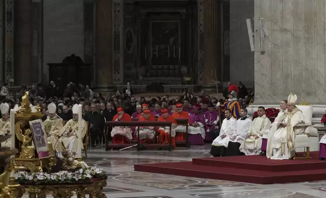 Pope Francis presides over the Christmas Eve Mass in St. Peter's Basilica at The Vatican, Tuesday, Dec. 24, 2024, after opening the basilica's holy door marking the start of the Catholic jubilar year 2025. (AP Photo/Andrew Medichini)