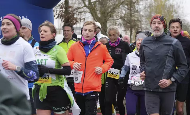 Belgian ultra runner Hilde Dosogne, center, runs with the pack during her 366th consecutive marathon in Ghent, Belgium, Tuesday, Dec. 31, 2024. (AP Photo/Virginia Mayo)