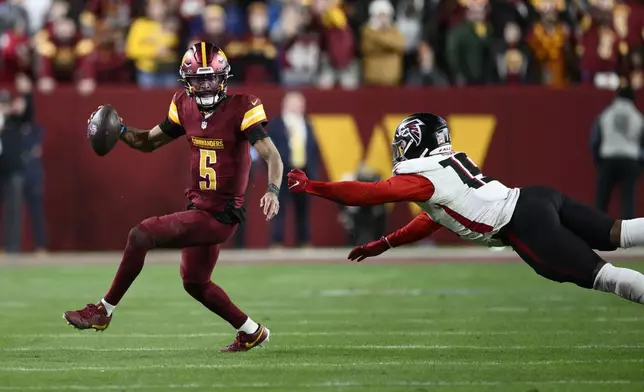 Washington Commanders quarterback Jayden Daniels (5) scrambles away from Atlanta Falcons offensive tackle Brandon Parker (75) in overtime during an NFL football game, Sunday, Dec. 29, 2024, in Landover, Md. The Commanders won 30-24. (AP Photo/Nick Wass)