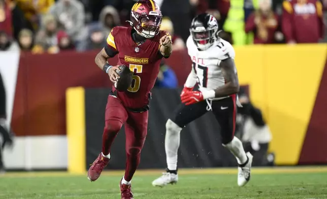Washington Commanders quarterback Jayden Daniels (5) carries on a keeper during the second half of an NFL football game against the Atlanta Falcons, Sunday, Dec. 29, 2024, in Landover, Md. (AP Photo/Nick Wass)