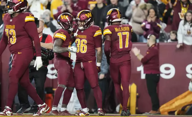 ]Washington Commanders running back Chris Rodriguez Jr. (36) celebrates his touchdown during the second half of an NFL football game against the Atlanta Falcons, Sunday, Dec. 29, 2024, in Landover, Md. (AP Photo/Stephanie Scarbrough)