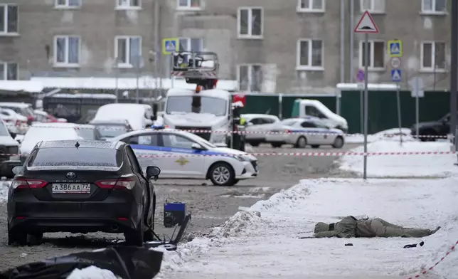 A body lies at the place where Lt. General Igor Kirillov, the head of Russia's Nuclear, Biological, and Chemical Defence Forces was killed by an explosive device planted close to a residential apartment's block in Moscow, Russia, Tuesday, Dec. 17, 2024. (AP Photo)