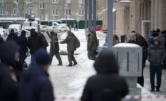 Investigators work at the place where Lt. General Igor Kirillov, the head of Russia's Nuclear, Biological, and Chemical Defence Forces was killed by an explosive device planted close to a residential apartment's block in Moscow, Russia, Tuesday, Dec. 17, 2024. (AP Photo)