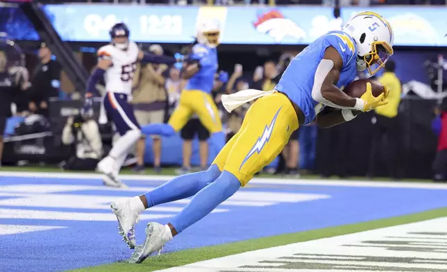 Los Angeles Chargers wide receiver Joshua Palmer (5) catches the ball in the end zone for a two-point conversion during the second half an NFL football game against the Denver Broncos, Thursday, Dec. 19, 2024, in Inglewood, Calif. (AP Photo/Ryan Sun)