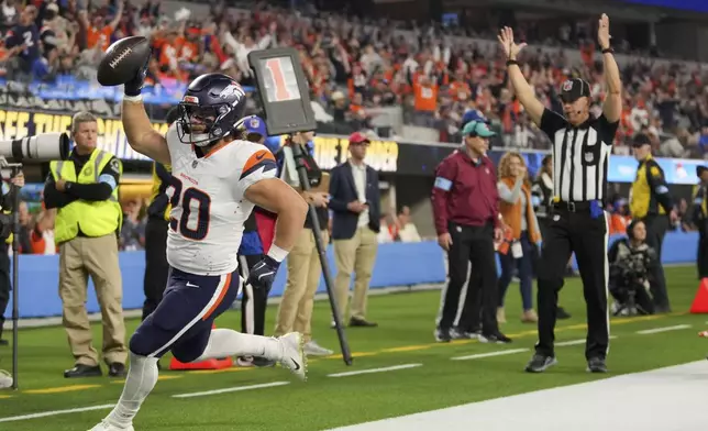 Denver Broncos fullback Michael Burton celebrates after catching a touchdown pass during the first half an NFL football game against the Los Angeles Chargers, Thursday, Dec. 19, 2024, in Inglewood, Calif. (AP Photo/Eric Thayer)