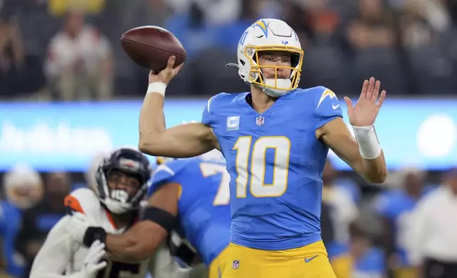 Los Angeles Chargers quarterback Justin Herbert (10) throws a pass during the first half an NFL football game against the Denver Broncos, Thursday, Dec. 19, 2024, in Inglewood, Calif. (AP Photo/Eric Thayer)