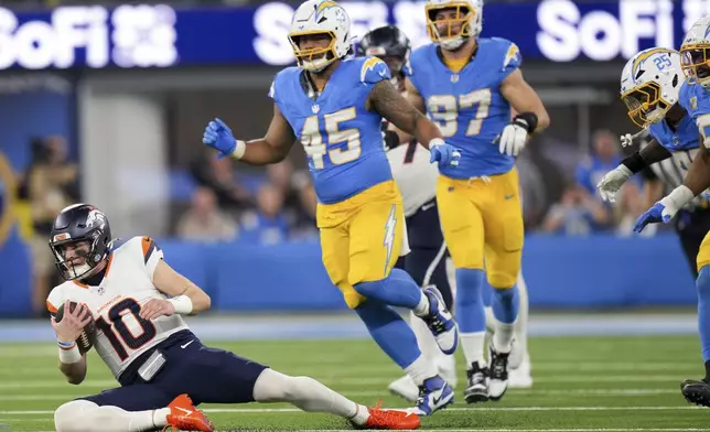 Denver Broncos quarterback Bo Nix (10) slides after gaining yards during the first half an NFL football game against the Los Angeles Chargers, Thursday, Dec. 19, 2024, in Inglewood, Calif. (AP Photo/Eric Thayer)