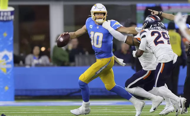 Los Angeles Chargers quarterback Justin Herbert (10) his pressured as he rolls out of the pocket during the second half an NFL football game against the Denver Broncos, Thursday, Dec. 19, 2024, in Inglewood, Calif. (AP Photo/Ryan Sun)