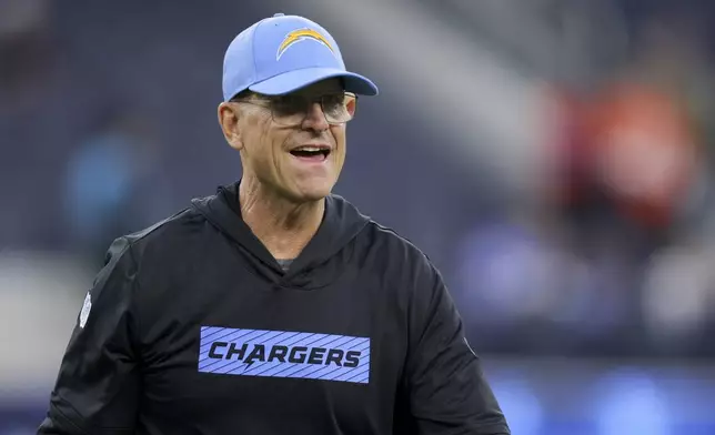 Los Angeles Chargers head coach Jim Harbaugh walks on the field before an NFL football game against the Denver Broncos, Thursday, Dec. 19, 2024, in Inglewood, Calif. (AP Photo/Ryan Sun)