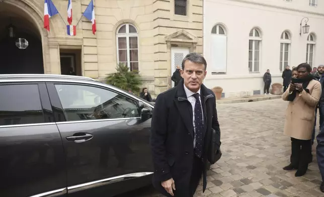 Emmanuel Valls arrives for the hand over ceremony at the ministry for Overseas Affairs in Paris, Tuesday, Dec. 24, 2024. (AP Photo/Thomas Padilla)