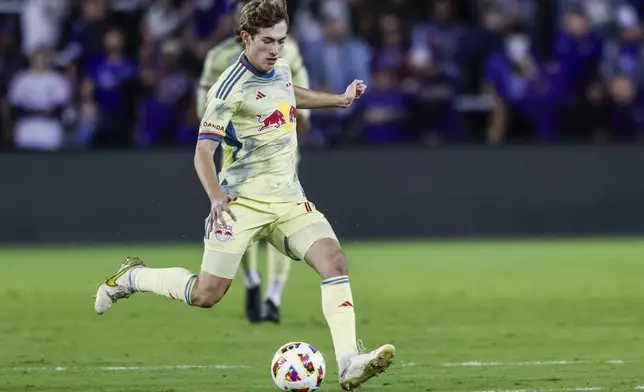 New York Red Bulls midfielder Daniel Edelman brings ball down the pitch against Orlando City during the first half of an MLS Eastern Conference final soccer match, Saturday, Nov. 30, 2024, in Orlando, Fla. (AP Photo/Kevin Kolczynski)