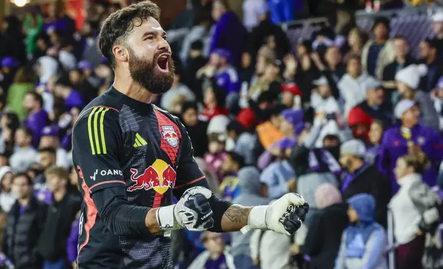 New York Red Bulls goalkeeper Carlos Miguel Coronel, react to fans after beating Orlando City in an MLS Eastern Conference final soccer match, Saturday, Nov. 30, 2024, in Orlando, Fla. (AP Photo/Kevin Kolczynski)