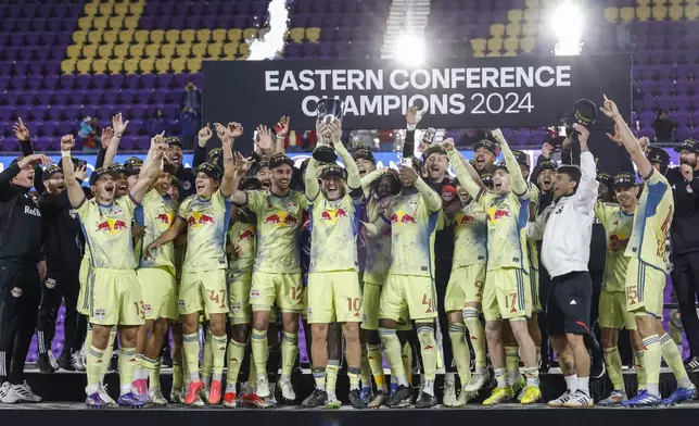 New York Red Bulls celebrate their championship after beating Orlando City in an MLS Eastern Conference final soccer match, Saturday, Nov. 30, 2024, in Orlando, Fla. (AP Photo/Kevin Kolczynski)