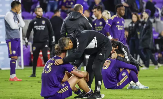 Members of Orlando City react to losing to the New York Red Bulls after the MLS Eastern Conference final soccer match, Saturday, Nov. 30, 2024, in Orlando, Fla. (AP Photo/Kevin Kolczynski)