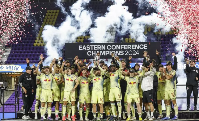 New York Red Bulls celebrate their championship after beating Orlando City in an MLS Eastern Conference final soccer match, Saturday, Nov. 30, 2024, in Orlando, Fla. (AP Photo/Kevin Kolczynski)