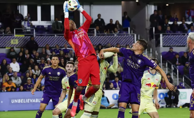 Orlando City goalkeeper Pedro Gallese (1) catches the ball on a goal attempt by the New York Red Bulls during the first half of an MLS Eastern Conference final soccer match, Saturday, Nov. 30, 2024, in Orlando, Fla. (AP Photo/Kevin Kolczynski)