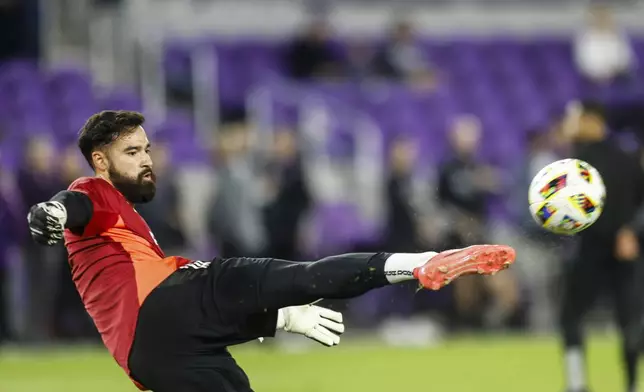 New York Red Bulls goalkeeper Carlos Miguel Coronel warms up before his team plays Orlando City in an MLS Eastern Conference final soccer match Saturday, Nov. 30, 2024, in Orlando, Fla. (AP Photo/Kevin Kolczynski)