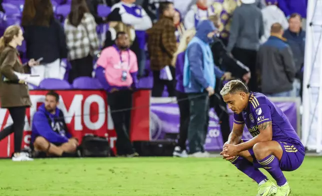 Orlando City forward Luis Muriel, right, reacts to loss against the New York Red Bulls after play in an MLS Eastern Conference final soccer match, Saturday, Nov. 30, 2024, in Orlando, Fla. (AP Photo/Kevin Kolczynski)