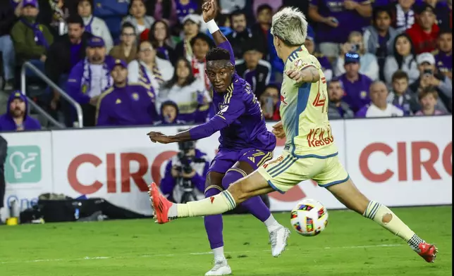 Orlando City midfielder Dagur Dan Þórhallsson, left, is defended by New York Red Bulls defender John Tolkin, right, during the second half of an MLS Eastern Conference final soccer match, Saturday, Nov. 30, 2024, in Orlando, Fla. (AP Photo/Kevin Kolczynski)